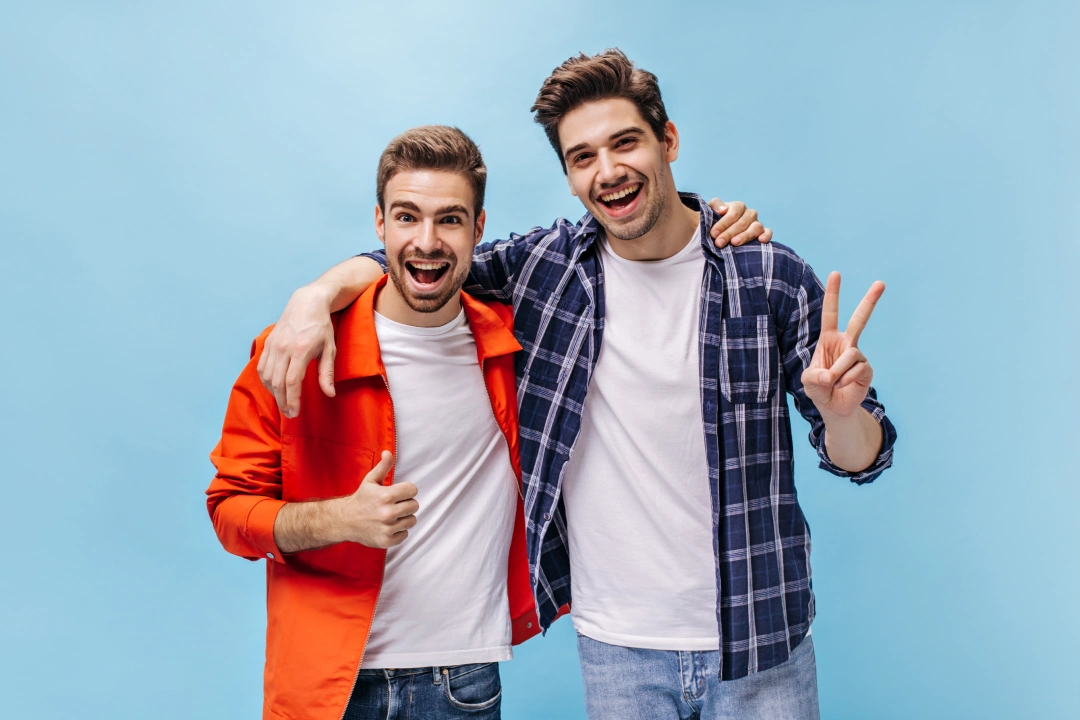 portrait-charming-brunet-men-white-tshirts-jeans-isolated-man-orange-jacket-show-thump-up-guy-checkered-shirt-show-peace-sign