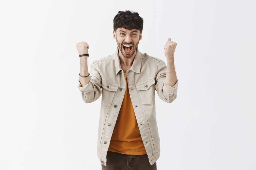 rejoicing-stylish-bearded-guy-posing-against-white-wall