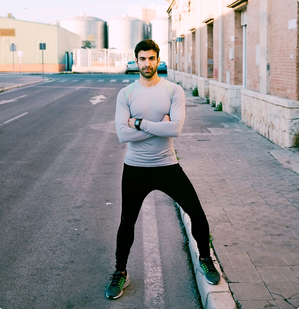 A man stands on a street corner, casually dressed, looking around as pedestrians pass by. A man stands on a street corner, casually dressed, looking around as pedestrians pass by.