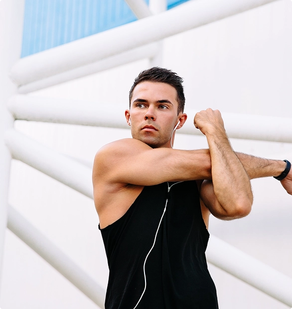 A man reaches out with his arm, indicating a moment of stretching or preparing for movement. A man reaches out with his arm, indicating a moment of stretching or preparing for movement.