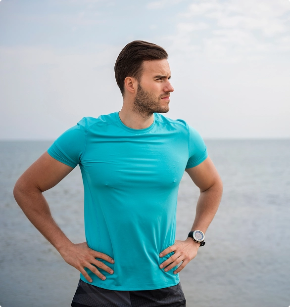 A man stretches his arm outward, demonstrating flexibility and readiness for physical activity. A man stretches his arm outward, demonstrating flexibility and readiness for physical activity.