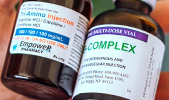 A close-up of a hand holding a B complex vitamin bottle, emphasizing the product's details.
