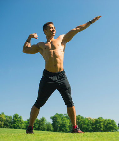 A man performs a push-up on green grass, focusing on his exercise routine in an outdoor setting. A man performs a push-up on green grass, focusing on his exercise routine in an outdoor setting.