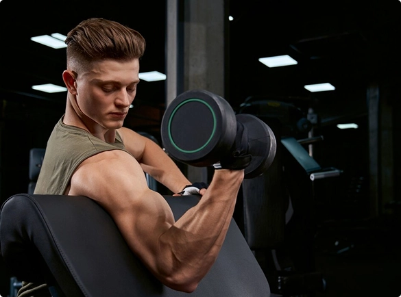 A man performs a workout, lifting a dumbbell with focus and determination.