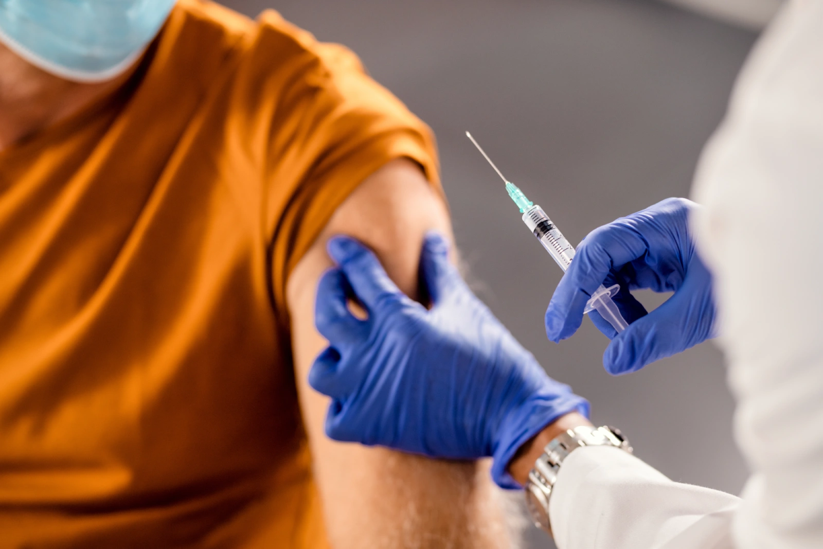 closeup-healthcare-worker-giving-vaccine-senior-patient