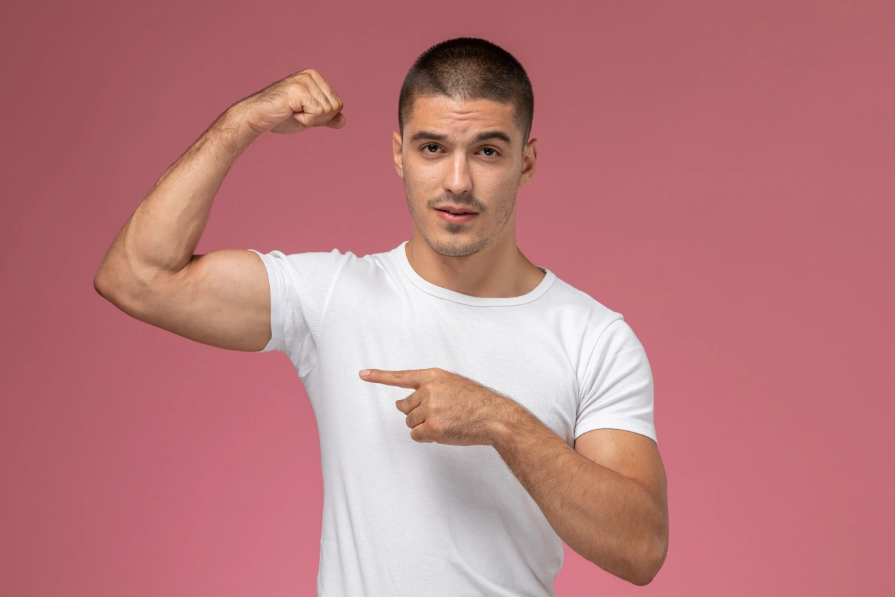 front-view-young-male-white-t-shirt-posing-flexing-pink-background