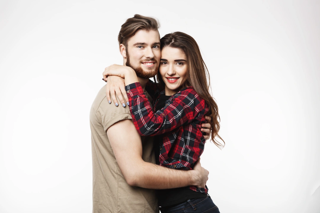 nice-couple-hugging-each-other-looking-camera
